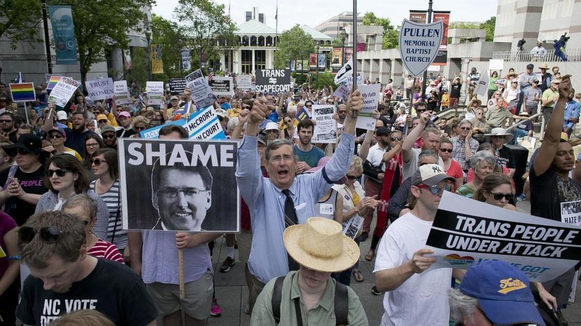 John Chase of Durham, center, follows the chants of North Carolina NAACP President Rev. William Barber during a rally in opposition of House Bill 2 in Raleigh, N.C. on Monday April 25, 2016.