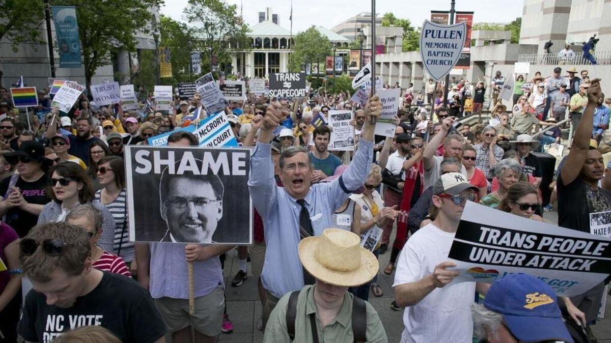 John Chase of Durham, center, follows the chants of North Carolina NAACP President Rev. William Barber during a rally in opposition of House Bill 2 in Raleigh, N.C. on Monday April 25, 2016.