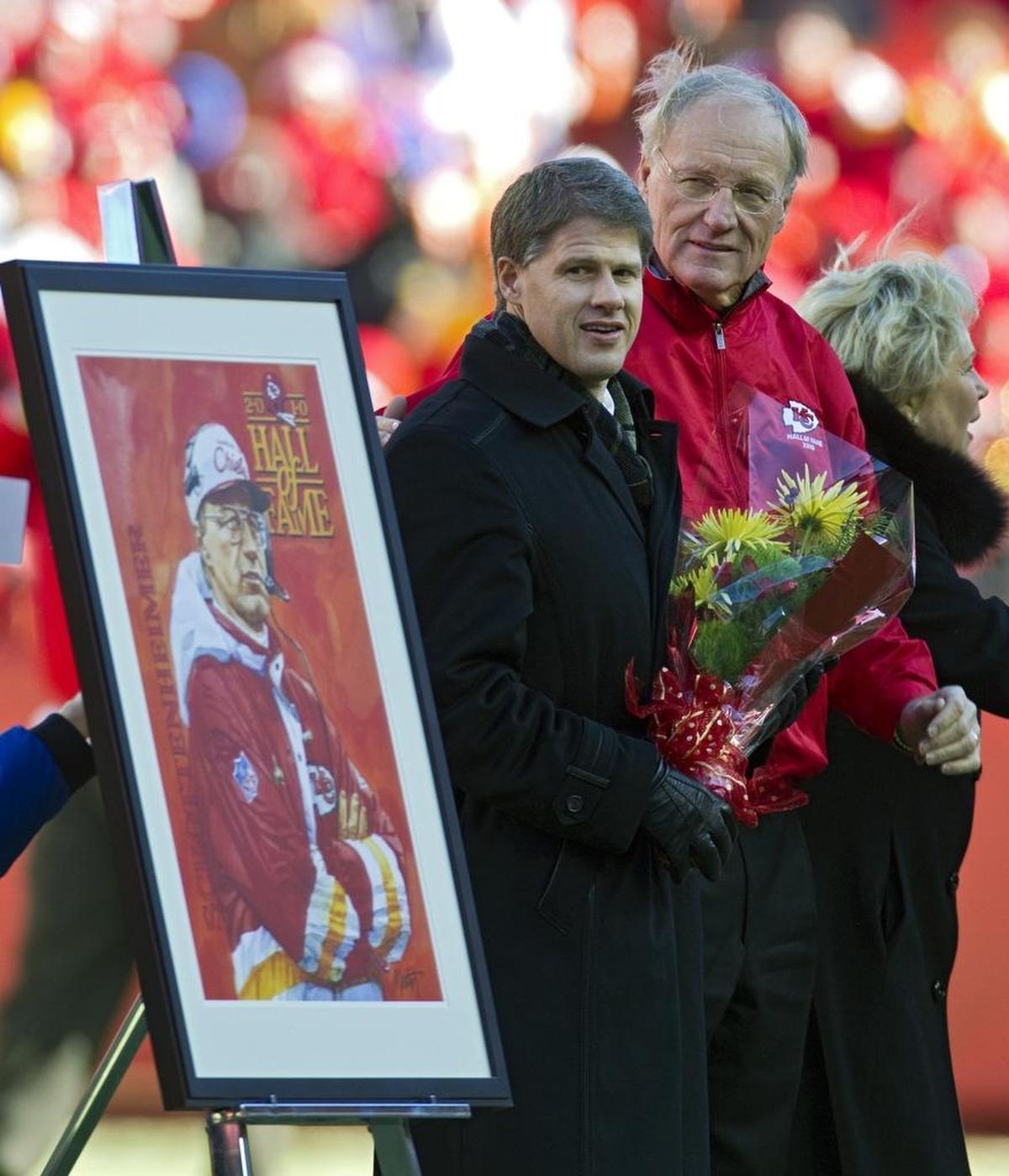 Former Kansas City Chiefs head coach Marty Schottenheimer and Chiefs owner Clark Hunt look at a commemorative print of Schottenheimer during a half-time ceremony inducting Schottenheimer into the Chiefs Hall of Fame at Arrowhead Stadium on Jan. 2, 2011.