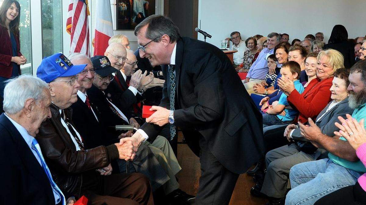 Denis Barbet, the French consul general to the American southeast, right, presents the French Legion of Honor medal to veteran Dudley Brown during Wednesday's ceremony. 18 WWII veterans from North Carolina received France's Legion of Honor medal in an afternoon ceremony at the Foundation of the Carolinas.