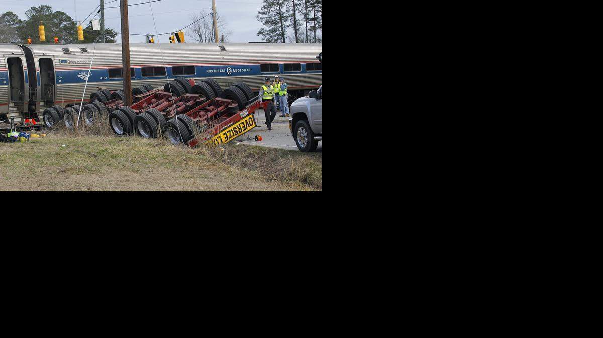 
A northbound Amtrak train collided with an oversized truck carrying an electrical building at the intersection of U.S. Hwy 301 and NC Hwy 903 in Halifax Monday. Over 200 passengers were on the train bound for New York. Some were injured but N.C. Highway Patrol spokesman Lt. Jeff Gordon said none of the injuries were life threatening. The upside-down trailer with the "Oversize Load" sign is the back end of the truck that was hit.
