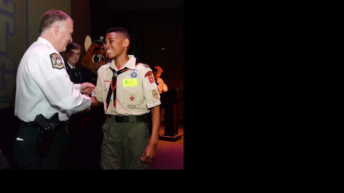 
Mecklenburg County Sheriff Irwin Carmichael (left) congratulates McCall Johnson 11, a fifth-grader at Irwin Academic Center, during a ceremony Tuesday at Discovery Place in uptown. McCall saw some older students were being mean to a younger child on a school bus, calling him names. McCall told them to leave the child alone then invited the child to sit with him on the bus. The two became friends, and according to the bus driver, the younger student went from not wanting to go to school to being excited about it again. McCall was one of seven Charlotte-Mecklenburg students students recognized for making good choices and “doing the right thing.”
