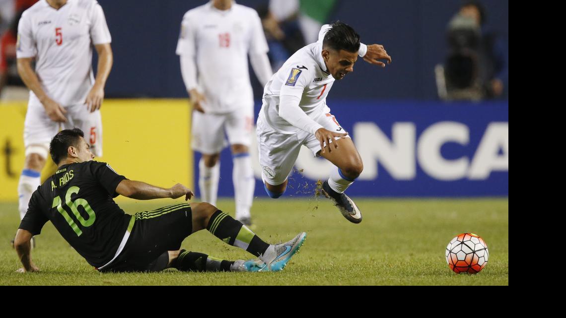 
Cuba midfielder Dario Suarez (7) trips up past Mexico midfielder Antonio Rios (16) during the second half of a CONCACAF Gold Cup soccer match, Thursday, July 9, 2015, in Chicago. Mexico won 6-0. 
