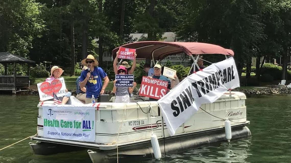 Protesters sailed outside of Sen. Thom Tillis’ lake house on Lake Norman Friday, demanding the senator speak with constituents about the U.S. Senate’s healthcare bill.