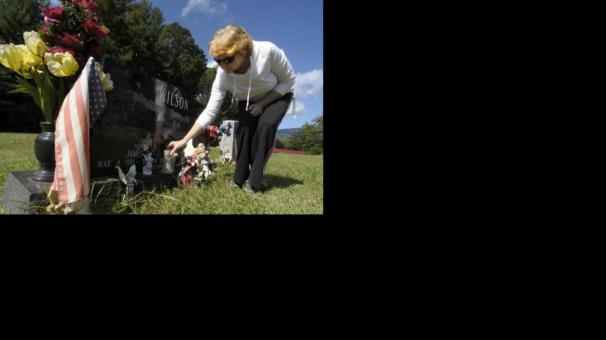 Kathy Wilson arranges angels on the marker at the cemetery in Andrews, NC. She had to pay to have her husband Jim's body exhumed because the medical examiner made the wrong ruling in his death. An autopsy showed James Wilson died of injuries sustained in a car wreck -- not of a heart attack. The distinction was important because his insurance policies didn't pay in case of a natural death. Her daughter Jenny is also buried in this spot, she passed away months after her step father. JEFF WILLHELM - jwillhelm@charlotteobserver.com