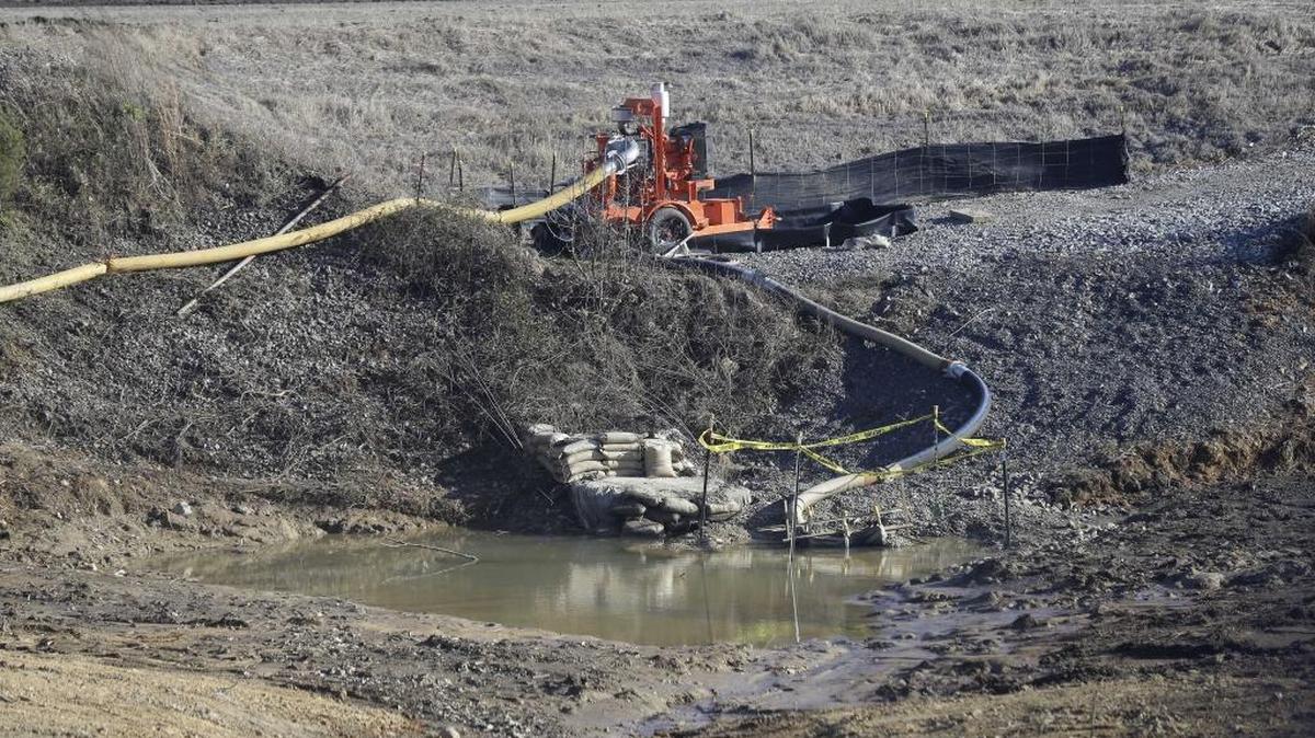A failed Duke Energy drainage pipe, shown being dug up in 2014, spilled coal ash into the Dan River. Duke said Friday it will post maps of potential flooding if any of its coal ash dams fail, after environmental advocates threatened to sue.