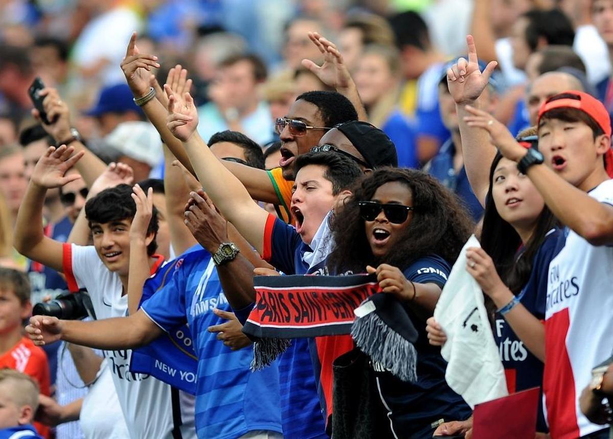 Paris Saint-Germain fans cheer on their team as it plays Chelsea in the International Champions Cup soccer match at Bank of America Stadium in Charlotte on July 25, 2015.