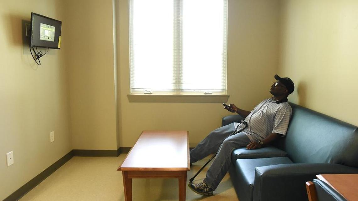 Ronnie White, 59, programs his television after turning it on for the first time in his new apartment in June. The Army veteran had been homeless for about 18 months in Charlotte before getting the apartment.