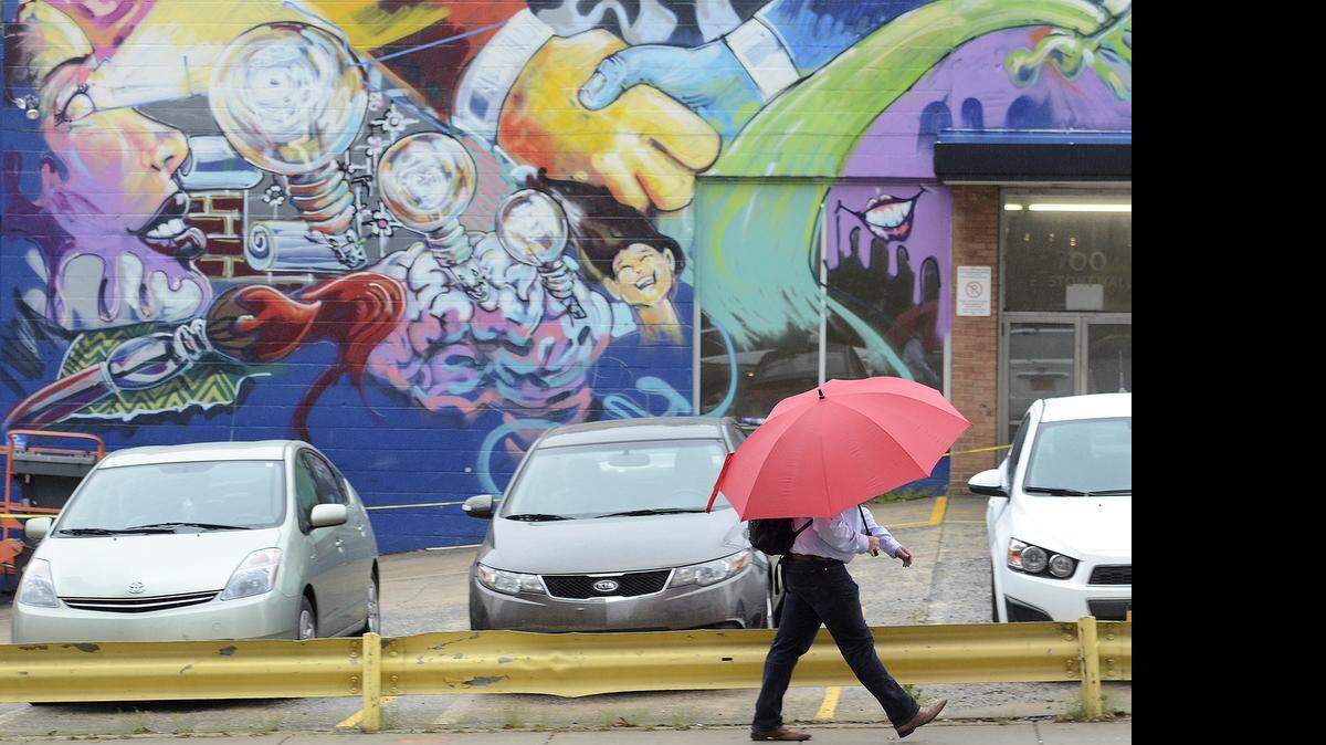
Mural artists added a splash of color to the former Goodyear auto shop at Stonewall and South Tryon streets uptown, prior to the building’s demolition to make way for a new office tower.
