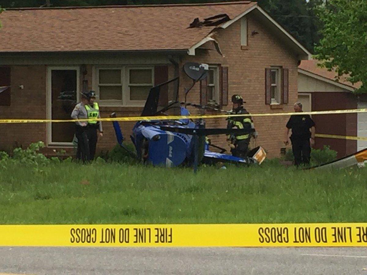 Two people were injured when a helicopter crashed and hit a home in Catawba County on Thursday afternoon.