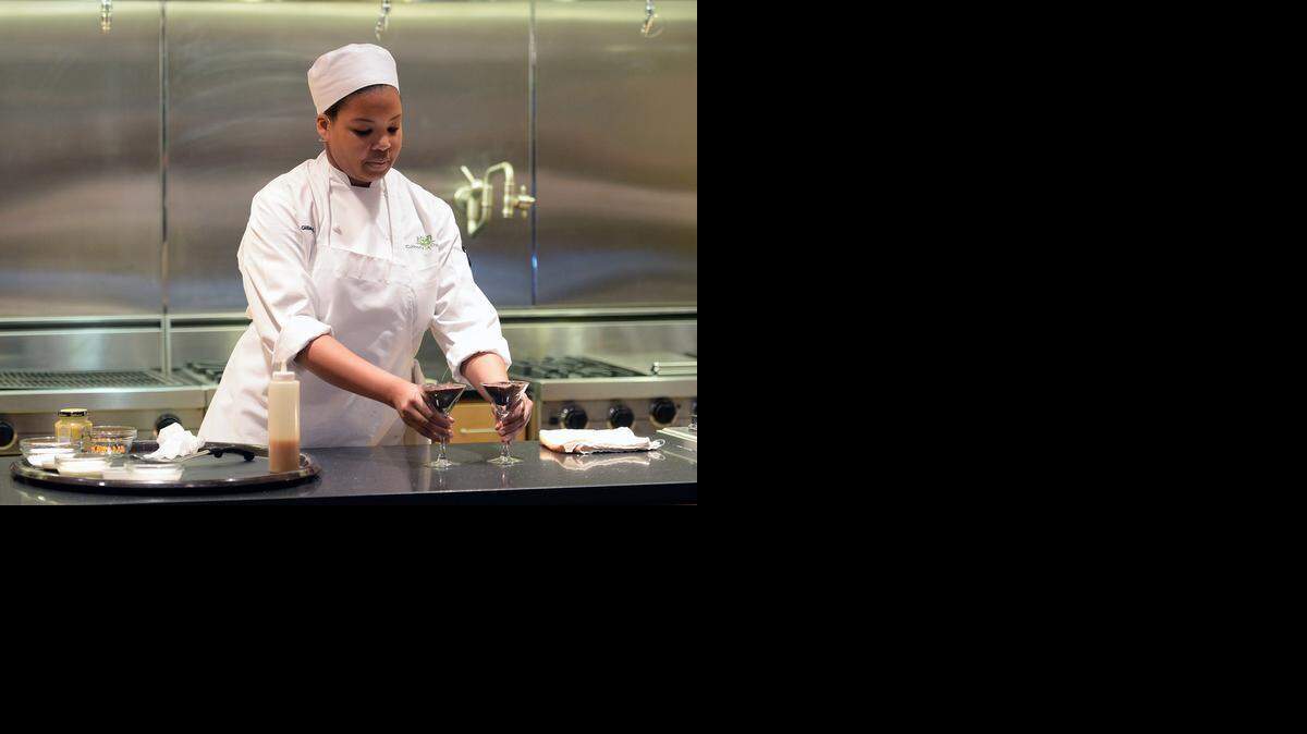 
Student chef Gillian Howard demonstrates for the judges and audience how she prepared her original recipe, Tennessee Date Night, at the S&D Coffee and Tea Culinary Challenge on Tuesday at Johnson & Wales University’s Charlotte campus. 
