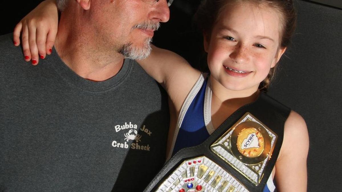 Lily Hutto, 8, shown with her father Tom Hutto, finished second Sunday at the 2017 U.S. Marine Corps Girls Folkstyle Nationals in Oklahoma.