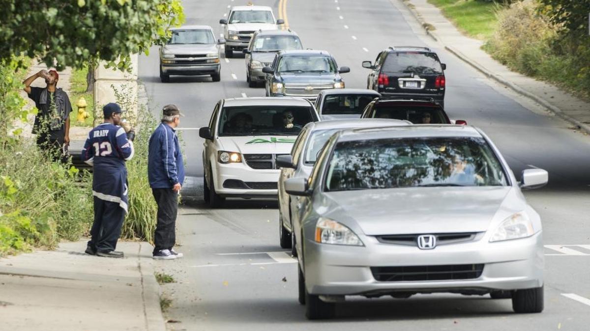 Homeless men gather at North Tryon Street near Dalton Avenue, which is just outside the area that will soon be a one-way road. Seven blocks between 23rd and 30th streets are involving in the project.