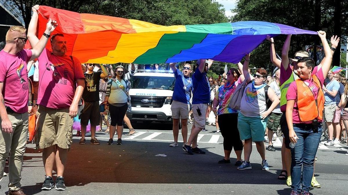 The rainbow flag is carried at the end of the 2017 Charlotte Pride Parade in uptown Charlotte.
