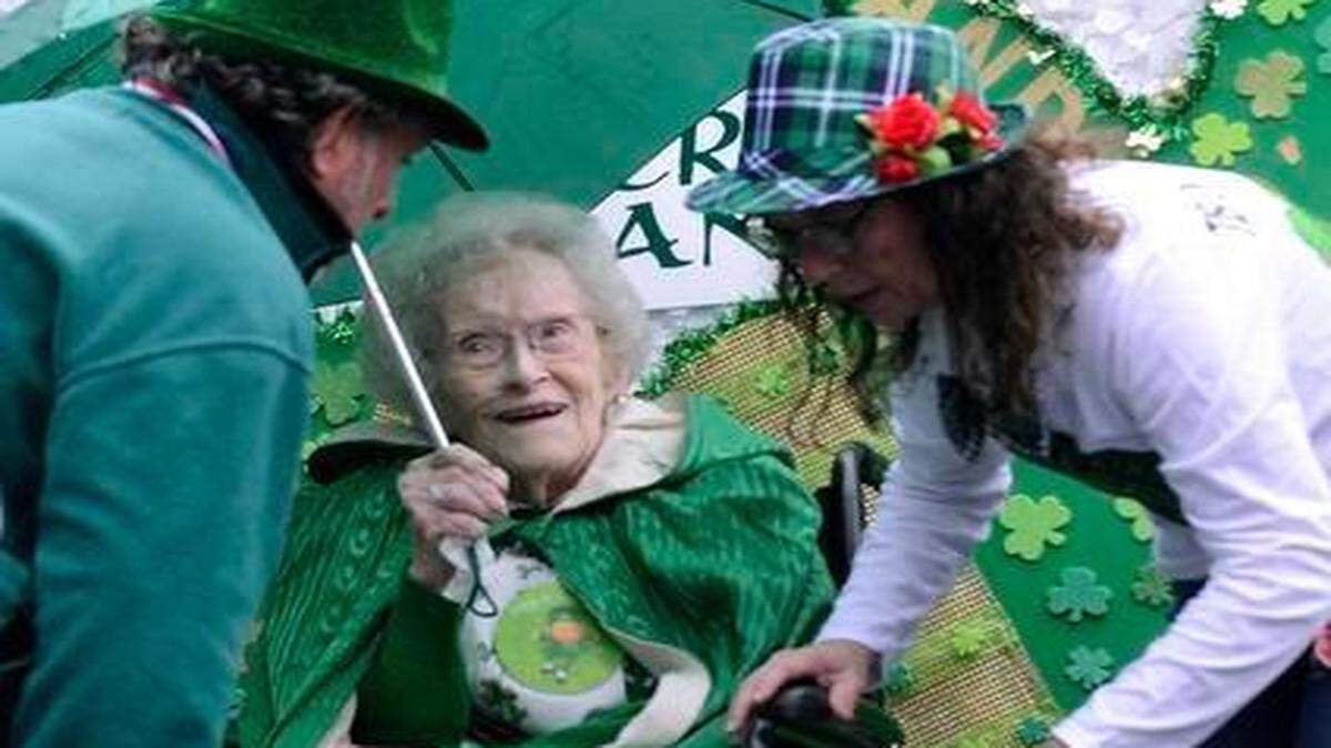 
Marty Quinn, left, and Kathleen Finnigan attend her 98-year-old mother Mary Virginia Federal before the St. Patrick’s Day parade. Charlotte’s 19th St. Patrick’s Day parade wove through a misty and cool uptown on Saturday. About 150 Federal family members and friends marched in the parade, many carrying air guitars playing along with the Federal Clan Kings, led by Michael and Lenny Federal. 
