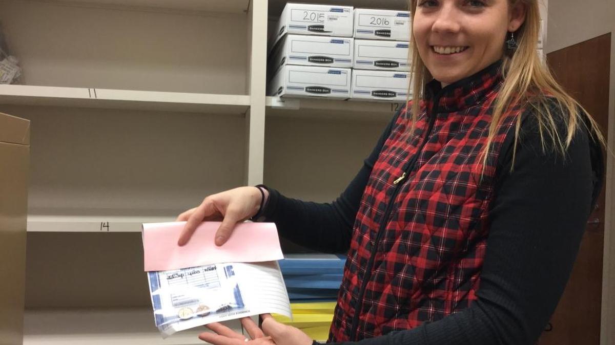 Deputy Coroner Brittany Keane holds an evidence bag filled with unclaimed jewelry never claimed by the decedent’s family at the York County Coroner’s Office.