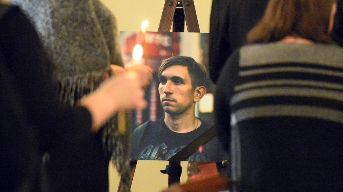 Friends and family members hold candles during the funeral service of Iaroslav Mosiiuk at JB Tallent Funeral Service on Monday, March 20, 2017. Mosiiuk was fatally shot by Charlotte-Mecklenburg Police on March 8.