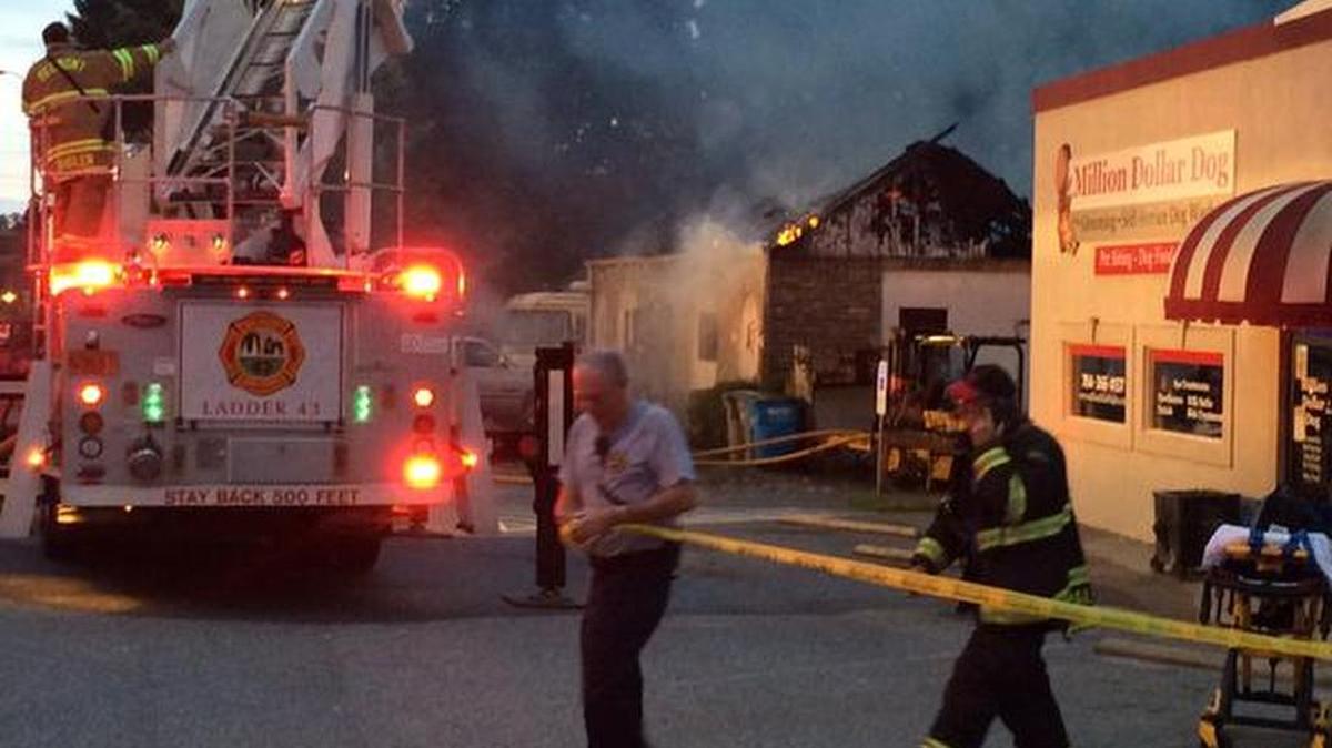 
Fire crews work to extinguish a building fire that closed Wilkinson Boulevard in Belmont Wednesday morning.
