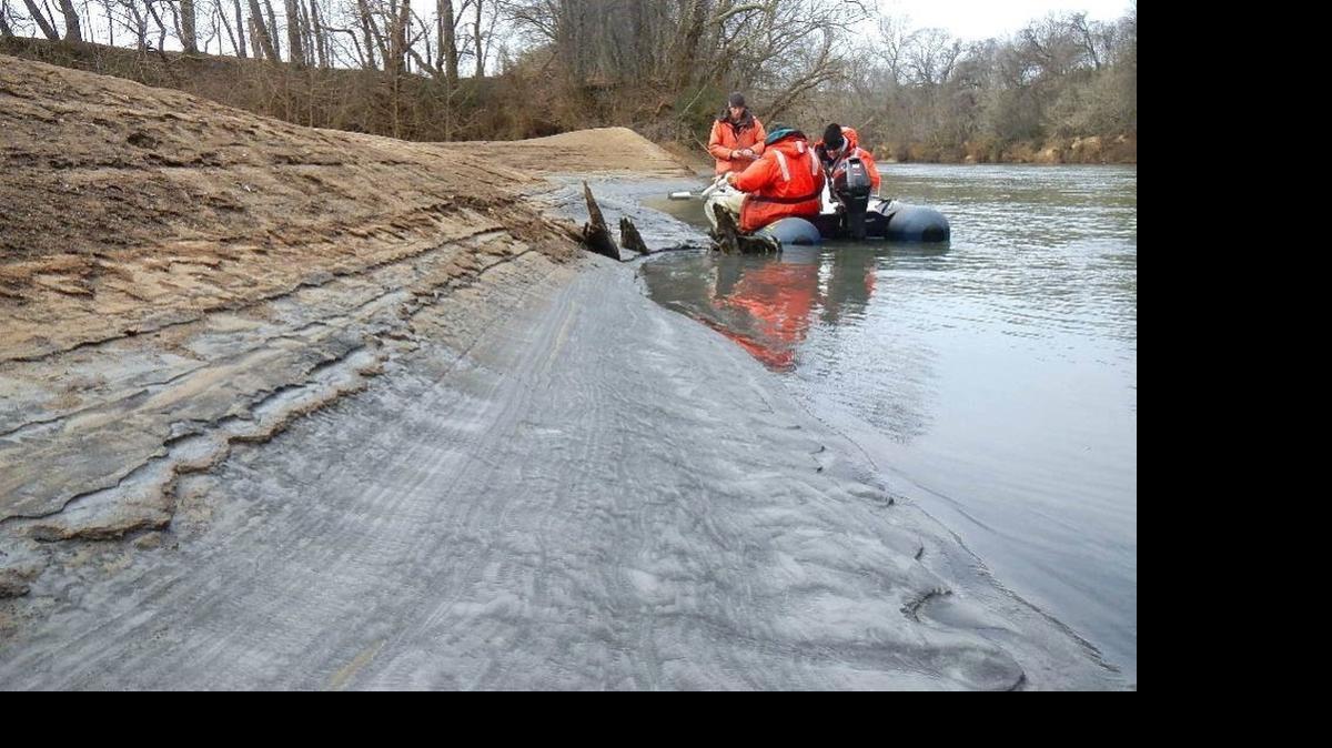 
Tom Augspurger, left, with the U.S. Fish and Wildlife Service takes a core sample six days after the Feb. 2, 2014, coal ash spill into the Dan River.
