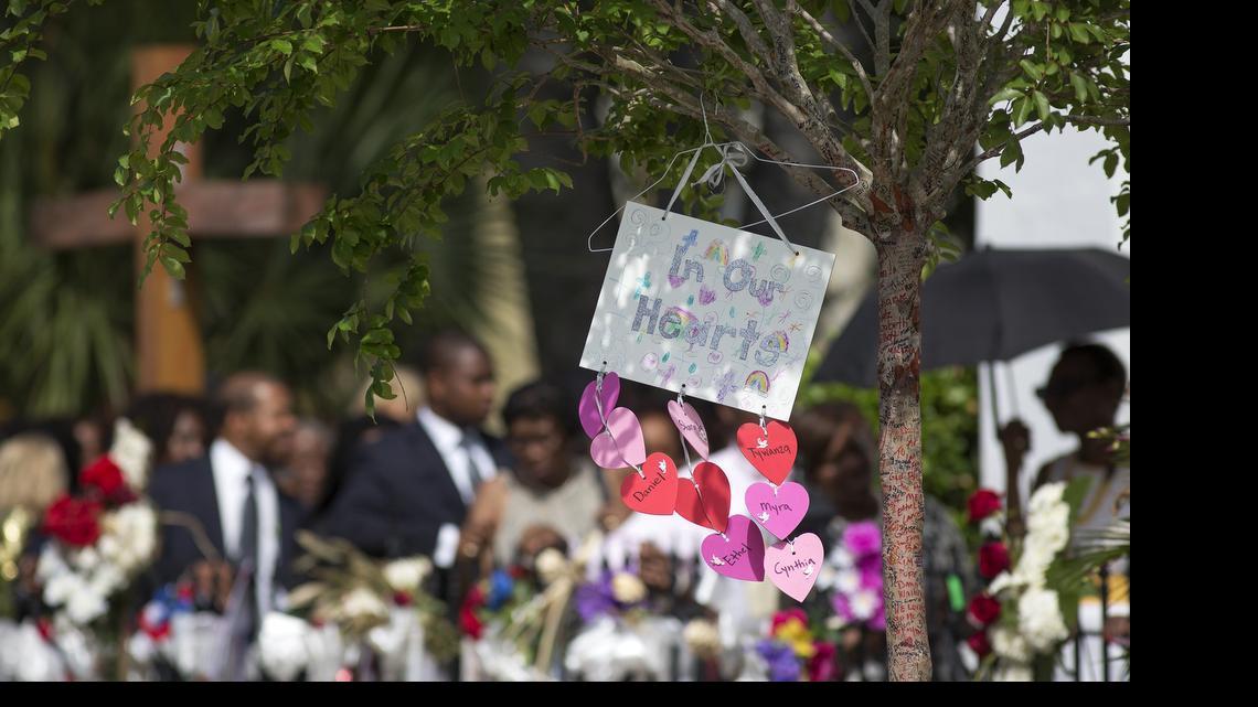
The name "Cynthia" can be seen in the bottom heart representing Cynthia Hurd before her funeral at Emanuel AME Church in Charleston, S.C. Members of Emanuel AME can be seen waiting in line in the background. (Photo by Mic Smith)
