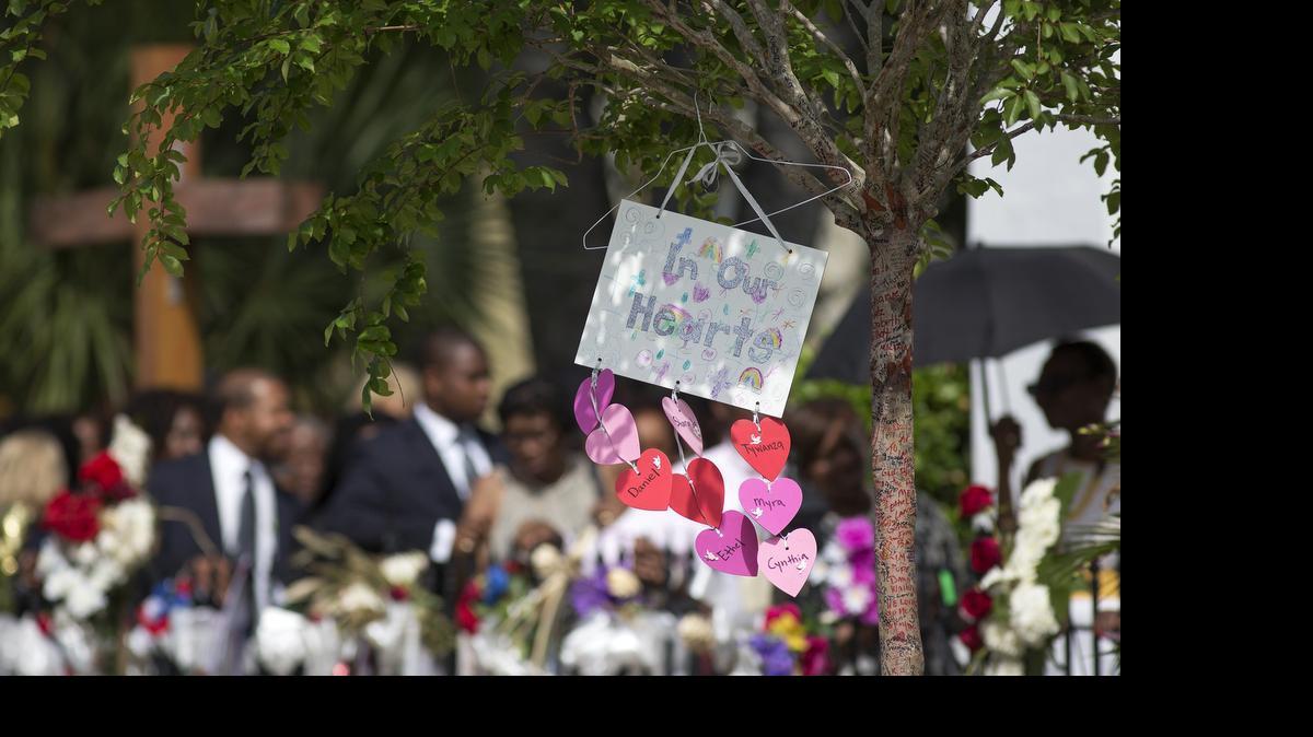 
The name "Cynthia" can be seen in the bottom heart representing Cynthia Hurd before her funeral at Emanuel AME Church in Charleston, S.C. Members of Emanuel AME can be seen waiting in line in the background. (Photo by Mic Smith)
