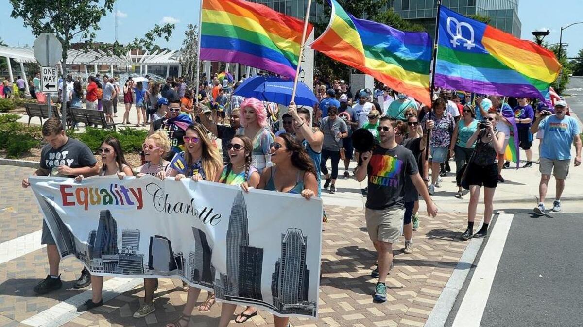 Participants march through First Ward Park in Charlotte during a 2017 Equality March, part of a nationwide series of marches for LGBTQ rights.