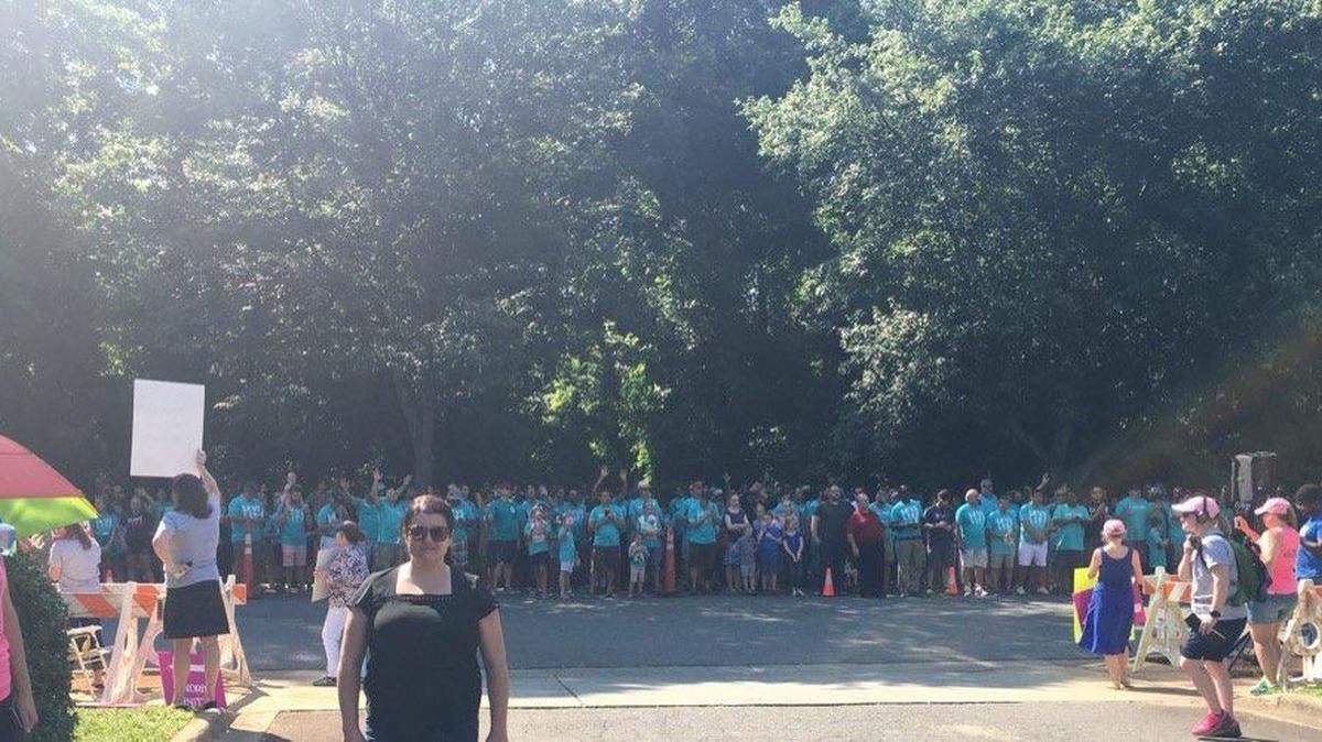 Calla Hales stands in front of a group of protesters rallying in front of her abortion clinic in Charlotte Saturday. Hales claims the city mistakenly gave the group a parade permit.