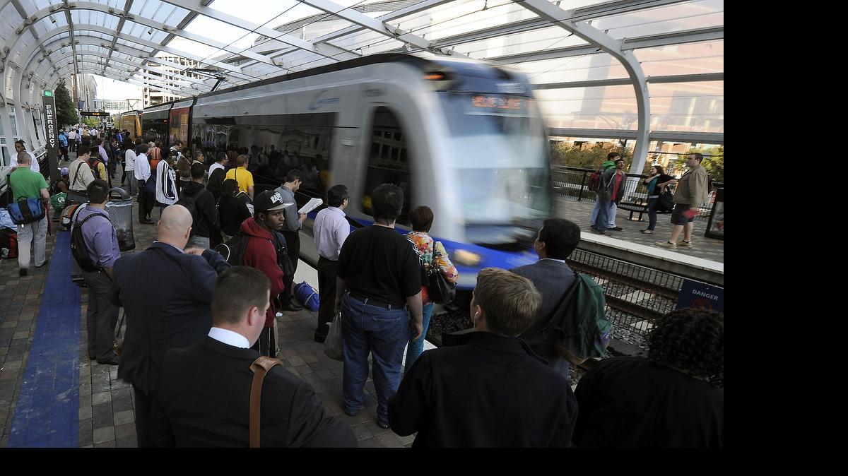 
Commuters stand on the platform at the Charlotte Transportation Center/Arena stop waiting to board the CATS' LYNX Blue Line light rail in this 2012 Observer file photo.
