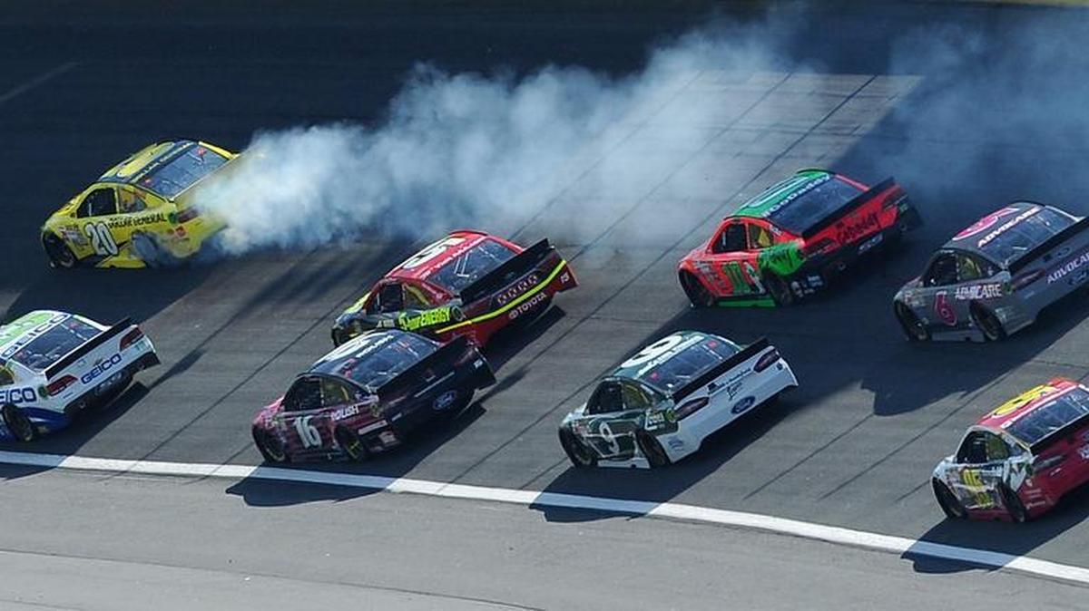 NASCAR Sprint Cup Series driver Matt Kenseth begins to kick up smoke as he enters Turn 1 during the 2015 Bank of America 500 at Charlotte Motor Speedway.