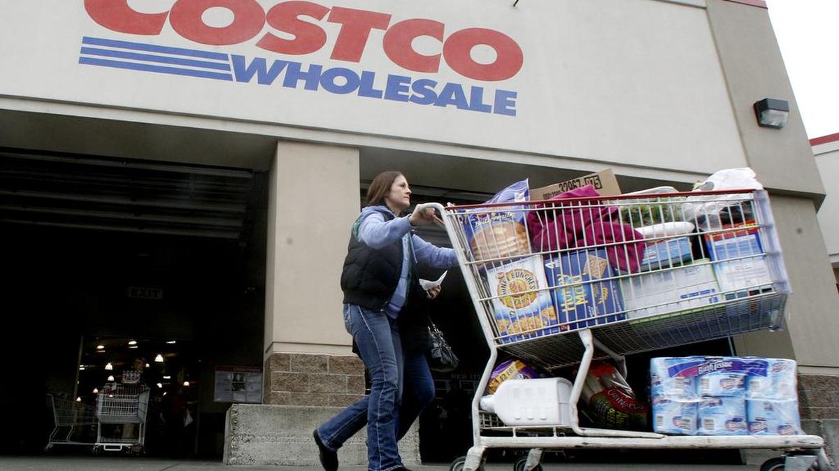 FILE - In this Dec. 7, 2011 file photo, a shopper leaves a Costco store in Portland, Ore.