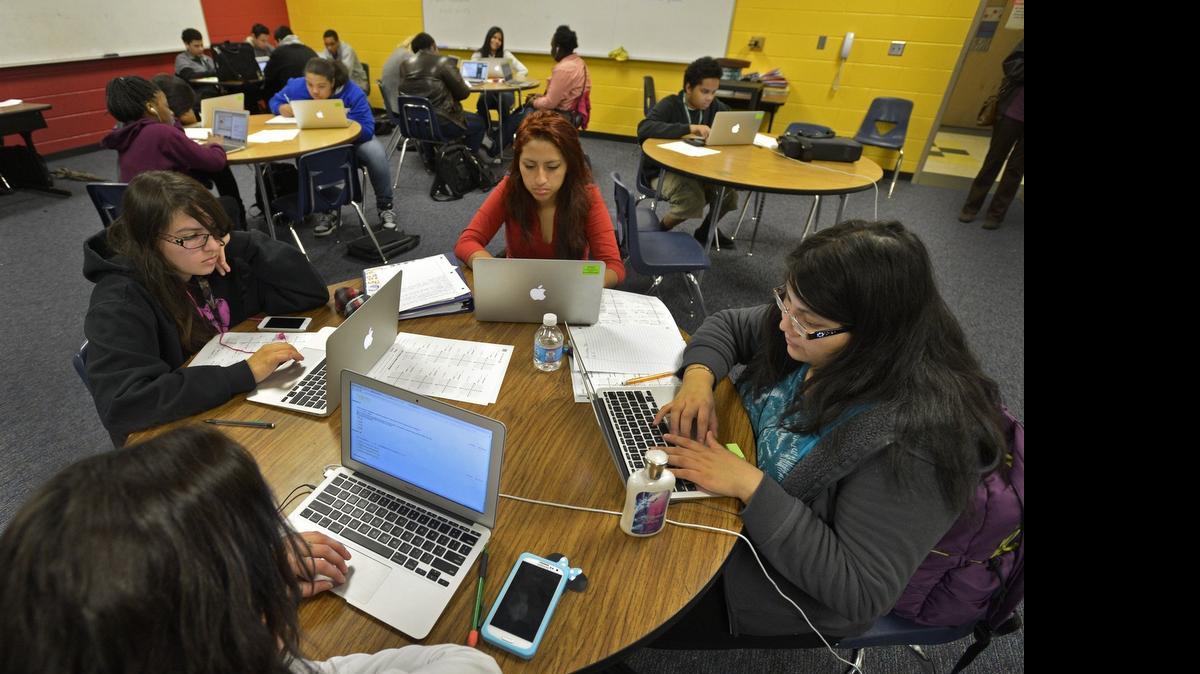 
Students Stephnie Quinteros (15), Elyse Manhollan (15), Maria Patino (15) and Estefany Carcamo (15) at work Monday Dec. 9, 2013, during their first-block math class online in a classroom designed as a digital lounge at the "iMeck Academy" magnet at Cochrane Collegiate Academy
