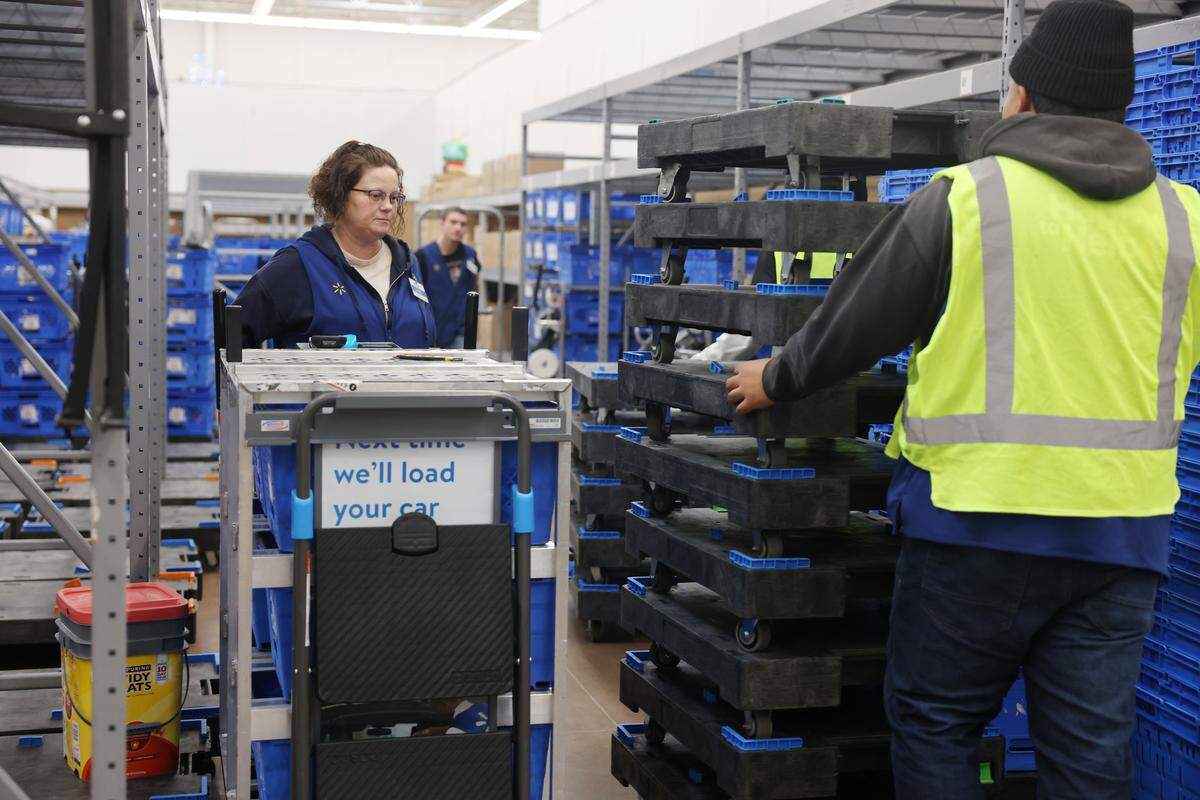 Jamie Foxworth, left, gets a cart ready to collect online orders Thursday at the Indian Trail Walmart.