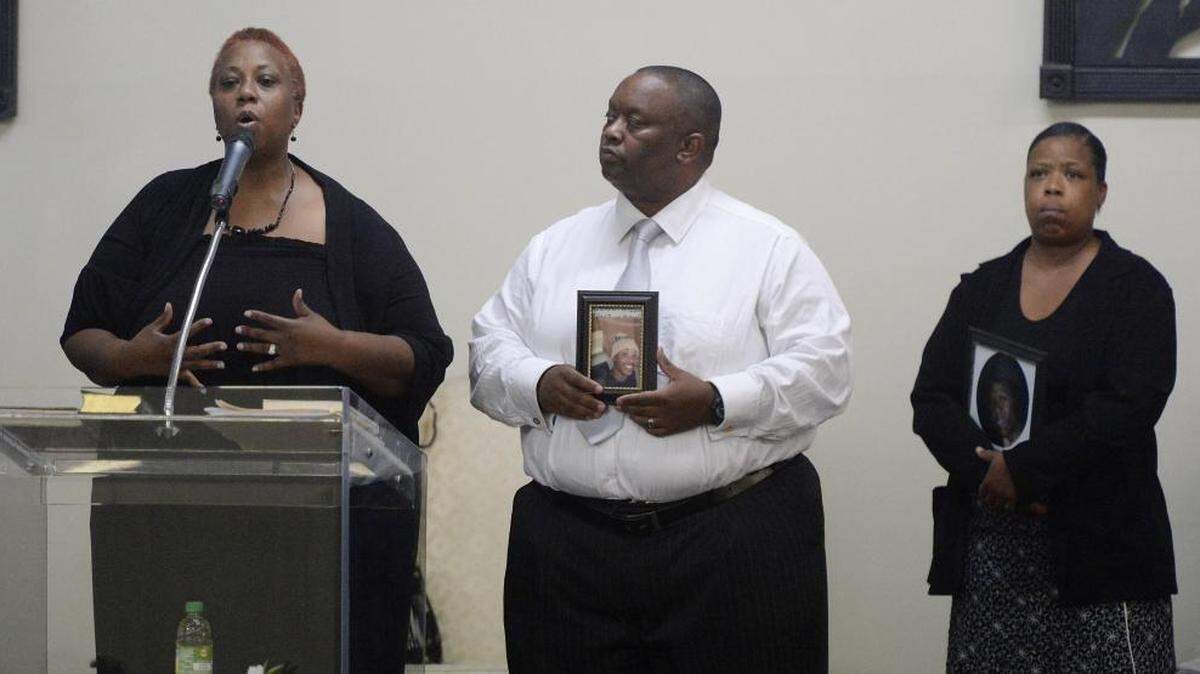 
Candice Greene, left talks about the death by Charlotte-Mecklenburg Police of stepson Devaron Wilborn, as husband Anthony Greene holds a photo of him, as Bonita Winchester, right, waits to talk about her son, Aaron Winchester, who was also killed by CMPD officers, during a justice rally on Sunday, August 23, 2015. The rally was led by John Barnett, founder of the True Healing Under God (THUG) civil rights group at Redemption Christian Ministries.
