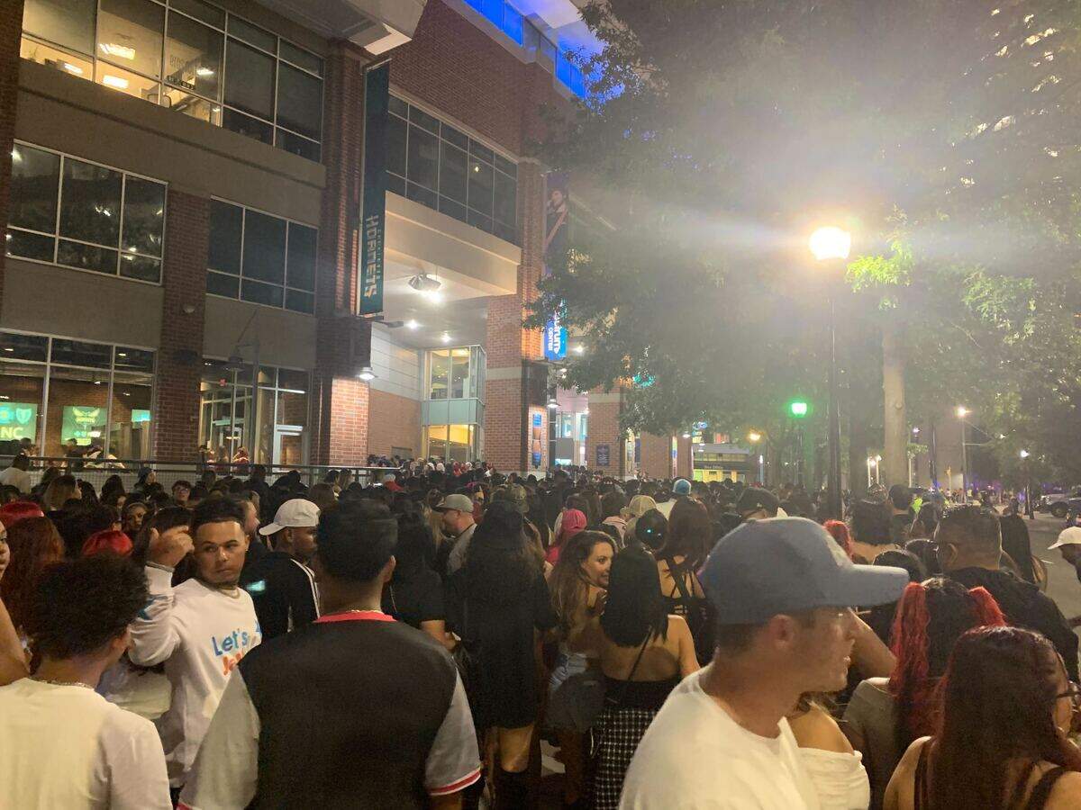 A crowd of people outside of the Spectrum Center Tuesday in uptown Charlotte for a Karol G concert.