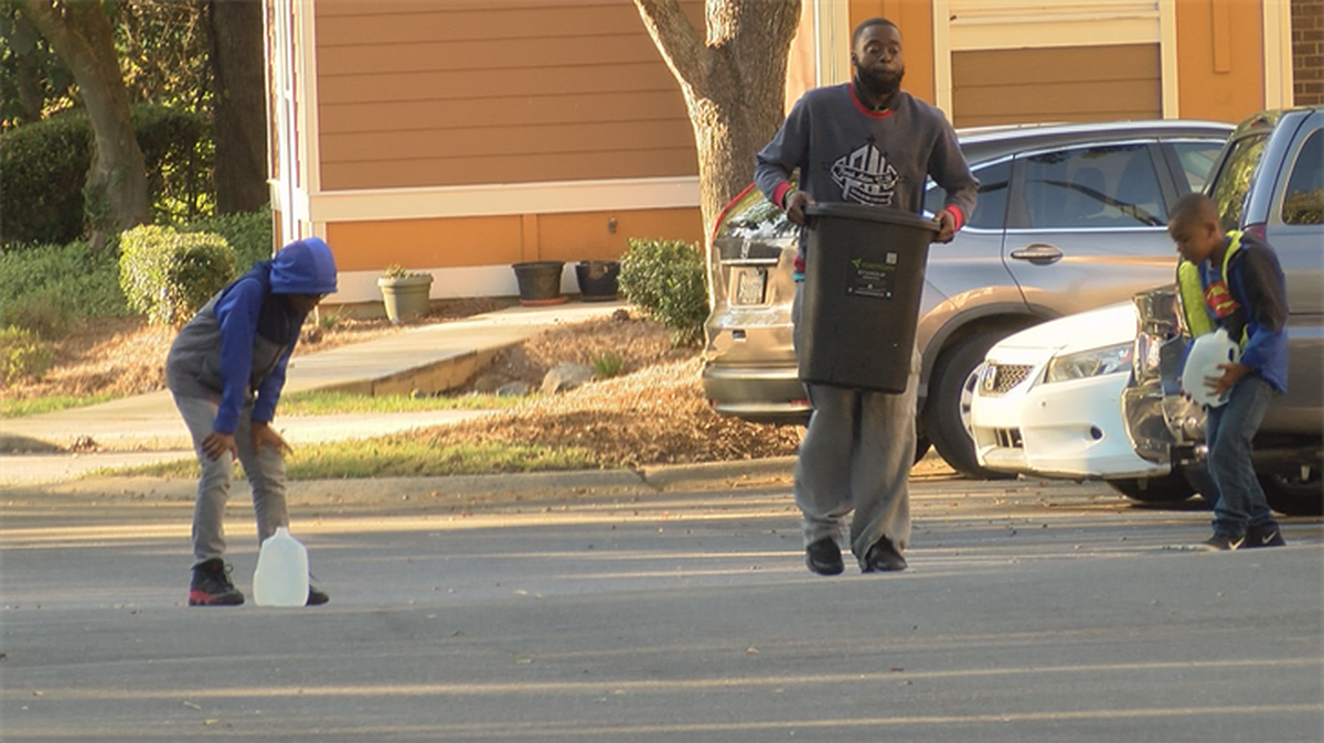 Residents of the apartments bring water home.