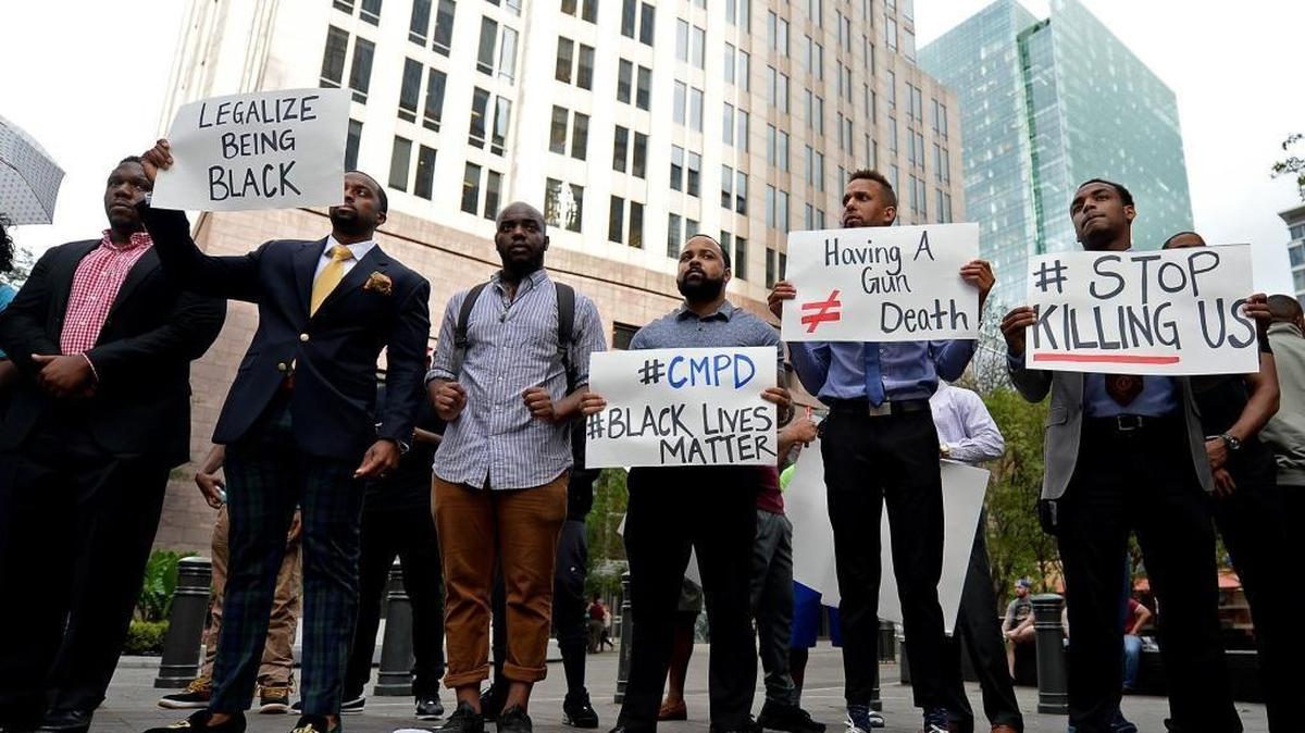 People gather at Trade and Tryon Streets in uptown Charlotte, NC on Wednesday afternoon in protest of the CMPD officer Brentley Vinson fatal shooting of Keith Lamont Scott on Tuesday evening at The Village at College Downs apartment complex in the University City area.
