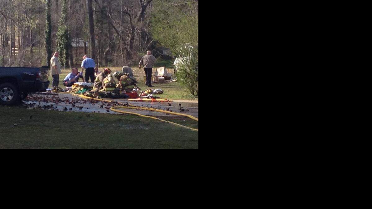 
Firefighters attend to one of two firefighters injured while fighting a house fire off Tirzah Road in Rock Hill Monday afternoon. 
