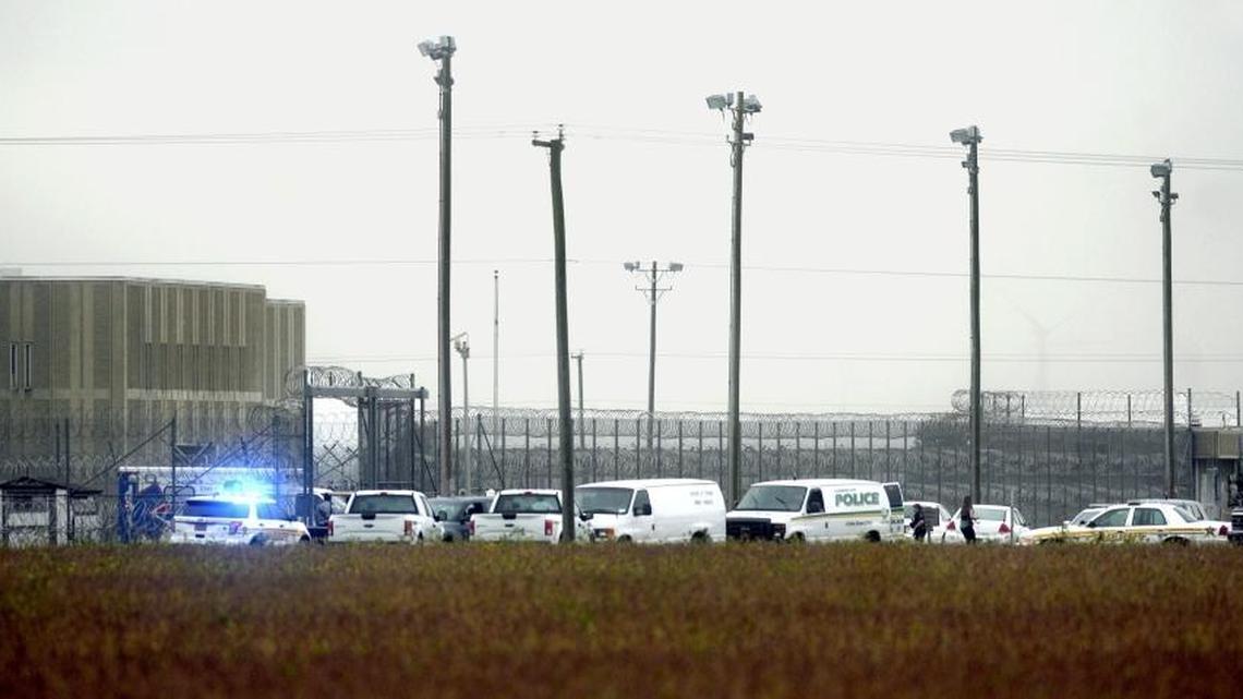 Police cars cluster outside Pasquotank Correctional Institution in Elizabeth City, N.C. on Oct. 12 following attacks that killed two employees.