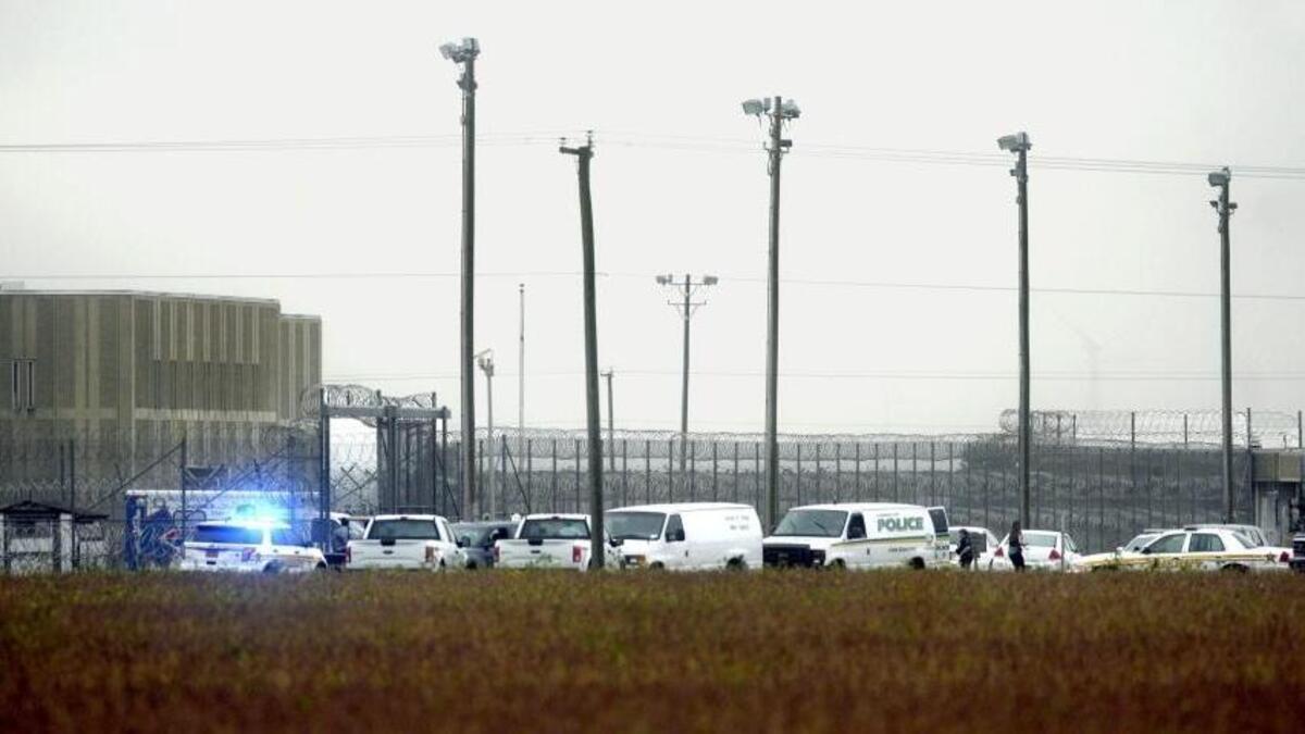 Police cars cluster outside Pasquotank Correctional Institution in Elizabeth City, N.C. on Oct. 12 following attacks that killed two employees.