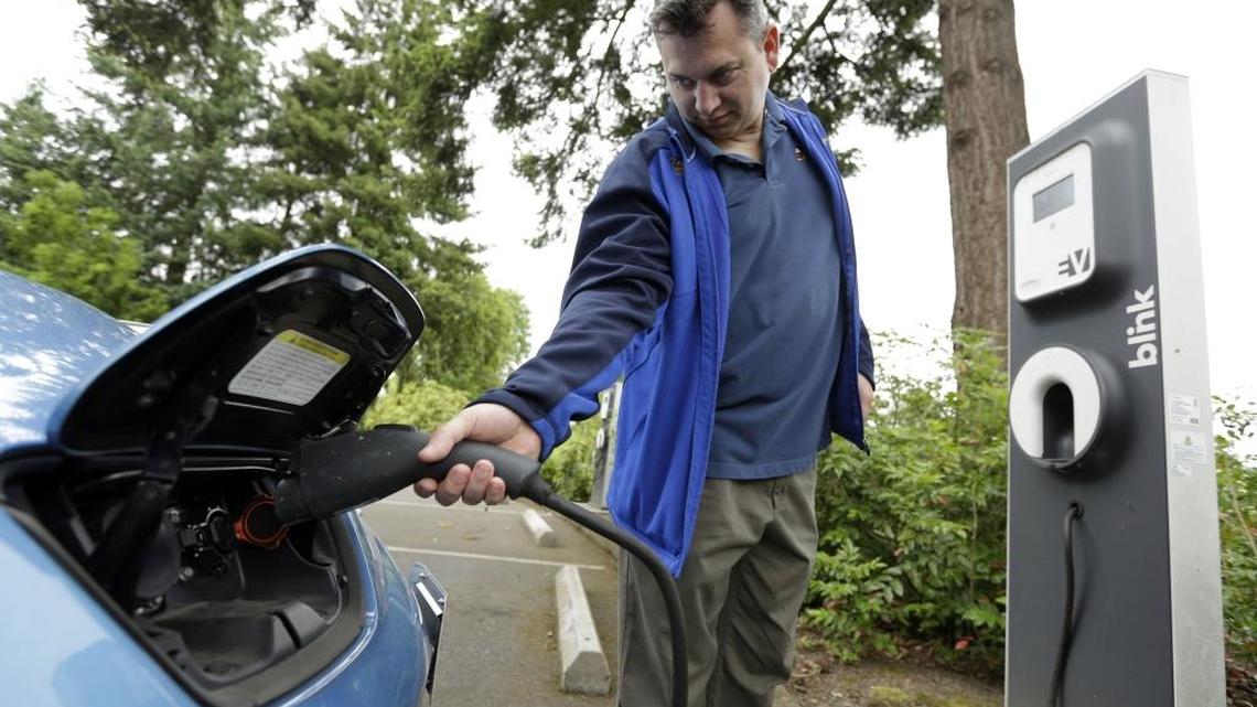 A Nissan Leaf electric vehicle charges up at a library in this 2015 photo.