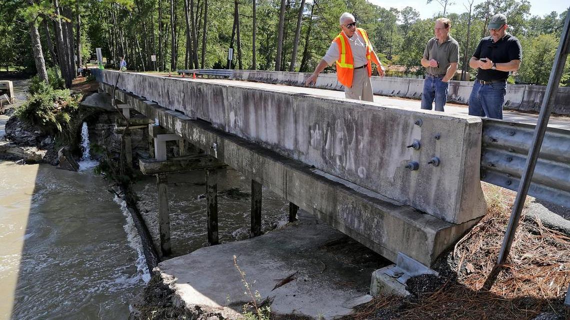 
From left, Grady Adkins, Todd Chambers and Tom Teuber, president of the Upper Rockyford Lake Homeowners Association, survey the dam at Overcreek Road in Columbia on Tuesday.
