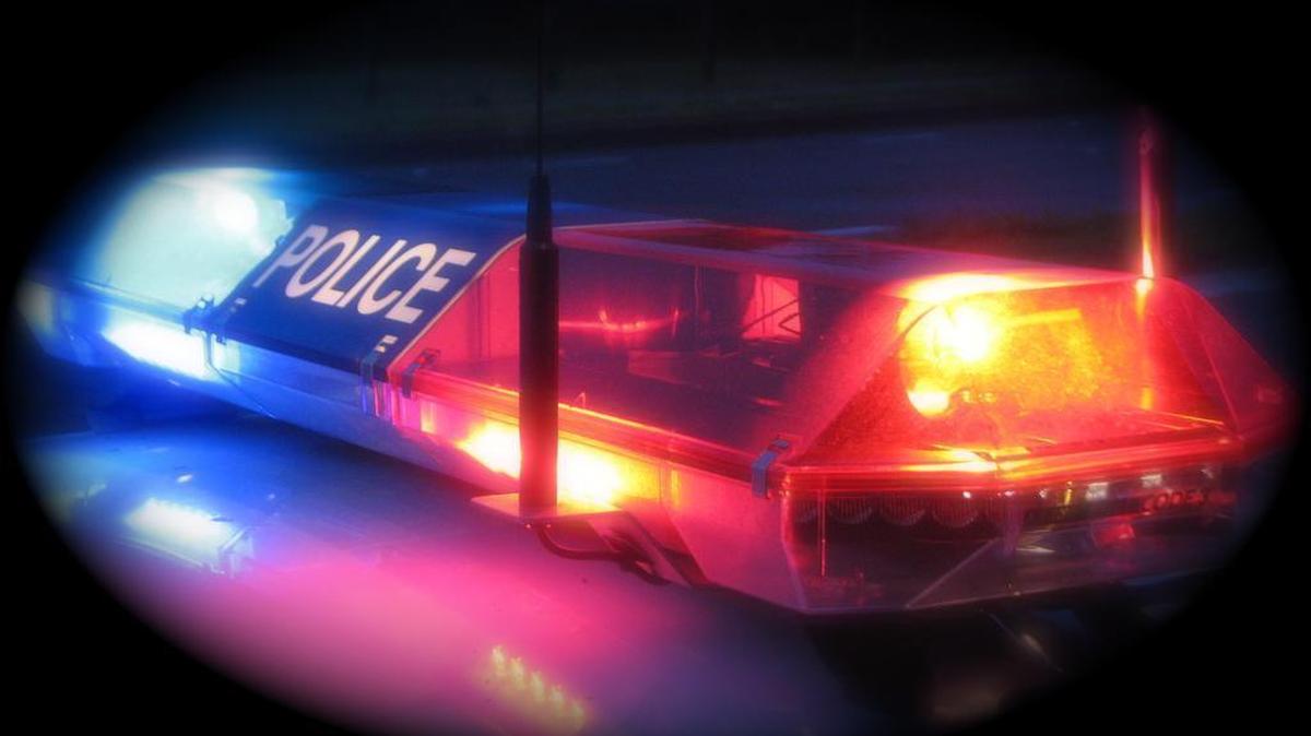 A police car flashes its lights.