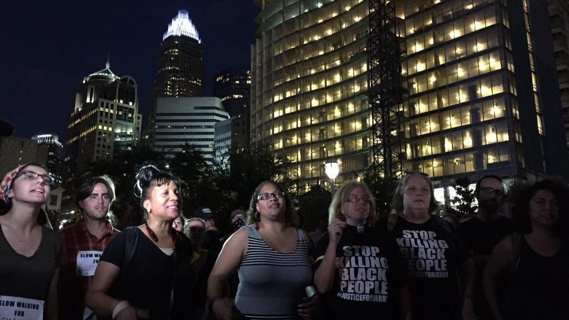 Protesters gather and chant slogans in Romare Bearden Park in Charlotte Thursday.