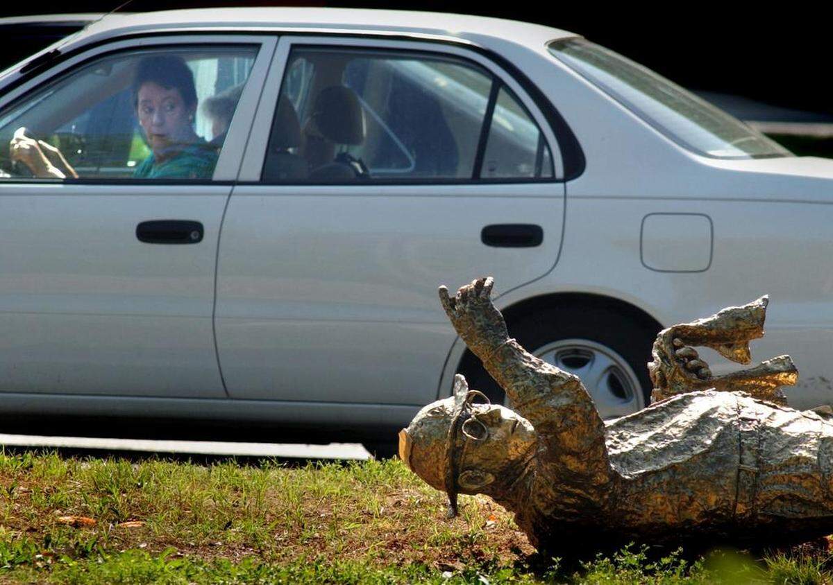 The Hugh McManaway statue lies in the grass after being hit by a car in 2002.