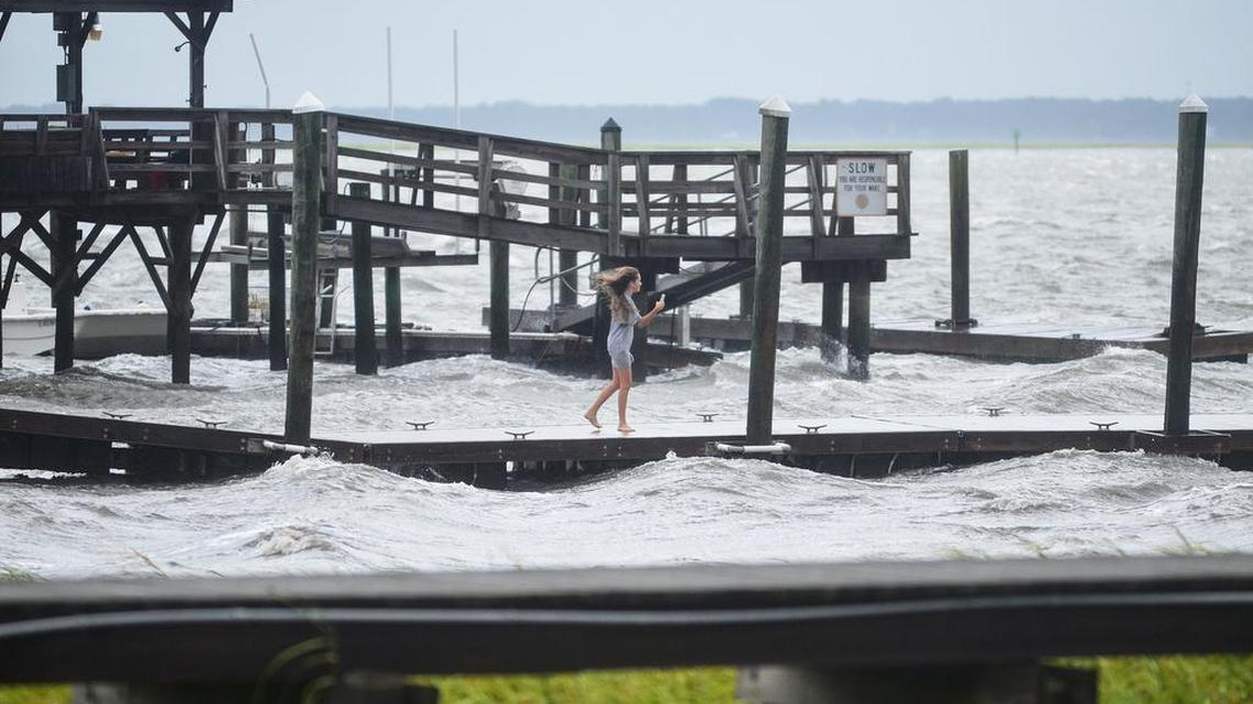A girl ventures out on the dock at All Joy Landing to get a closer picture of the waves generated by Tropical Storm Hermine as it passed near Bluffton, S.C., on Friday.