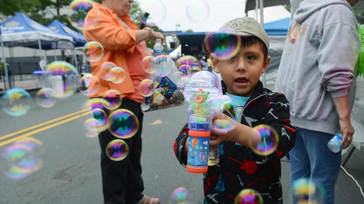 A Charlotte boy enjoys bubbles at one of the city’s immigrant heritage festivals, honoring contributions of newcomers to Charlotte. City leaders are working to make immigrants feel more welcomed.