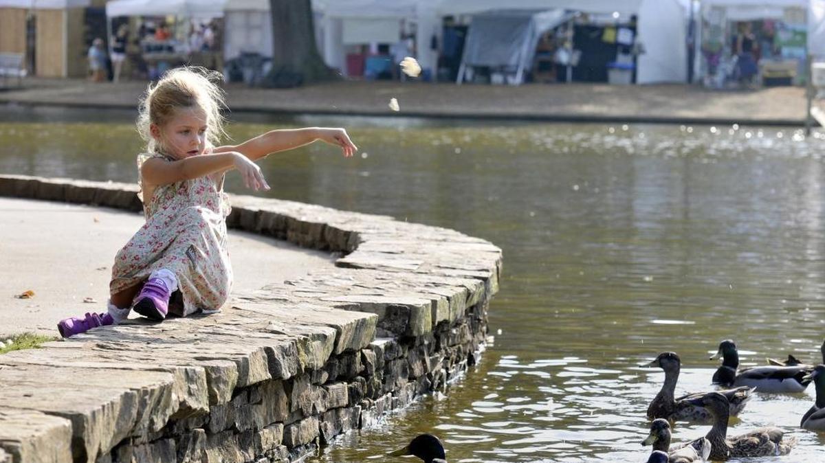 A girl feeds the ducks at Freedom Park during the annual Festival in the Park.