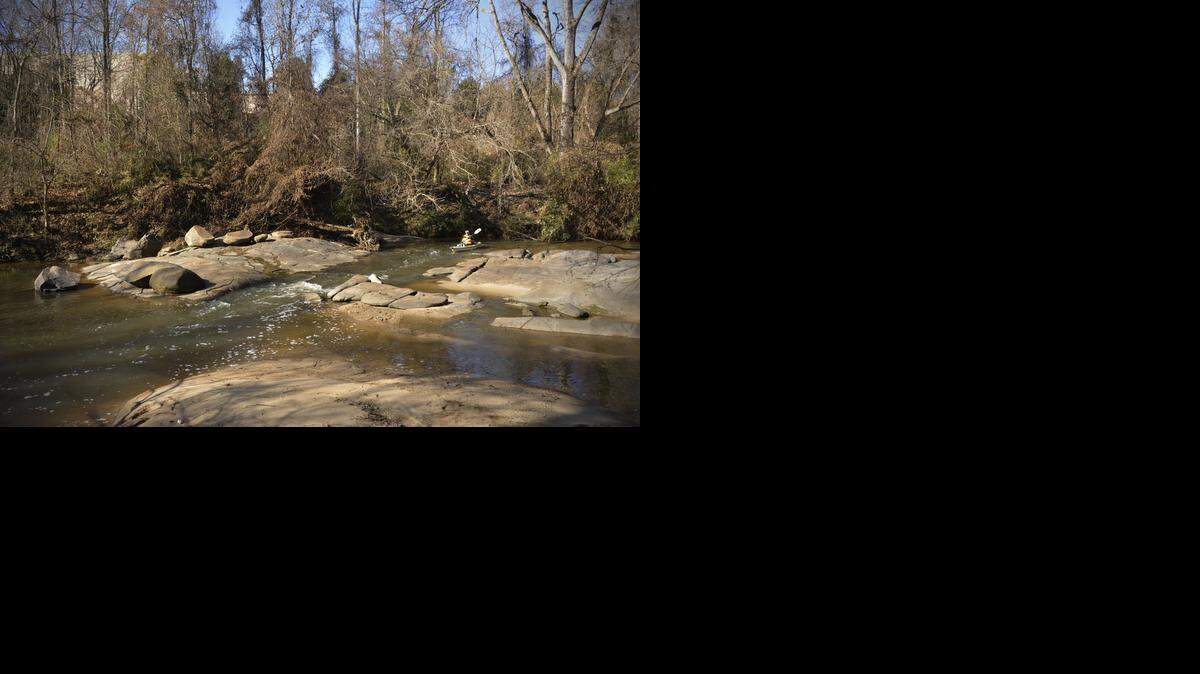 
A paddler runs a small rapid on a naturally flowing section of Little Sugar Creek in south Charlotte.

