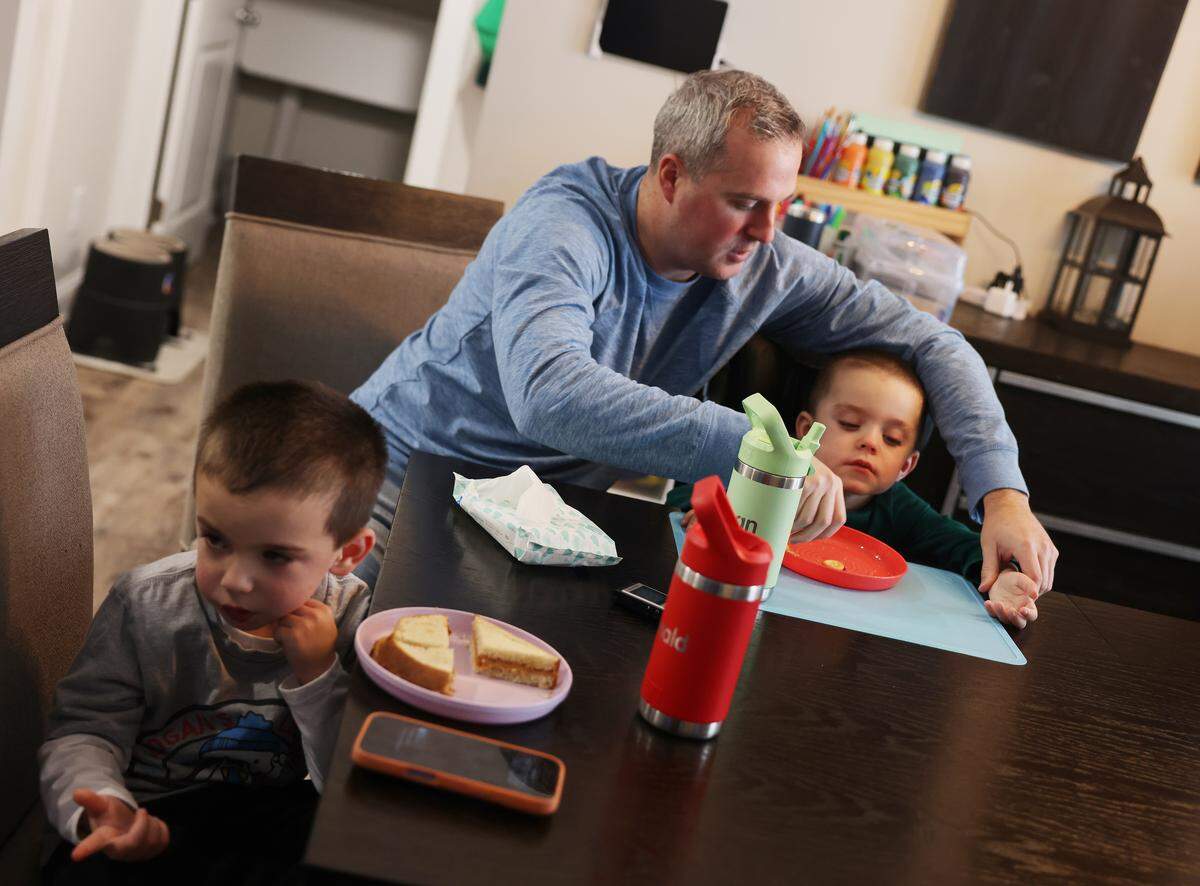 Kevin Reese feeds Logan as the brothers have lunch at home in Richfield.