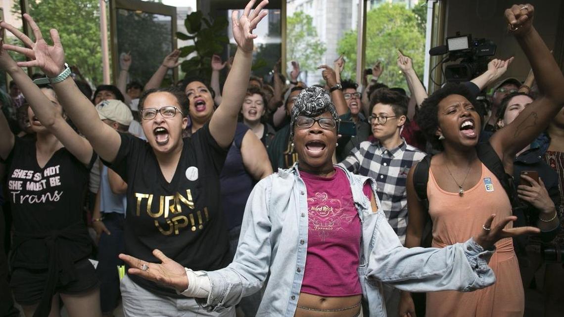 Krys Didtrey, left, and Gloria Merriweather, center, of Charlotte lead chants in opposition to HB2 during a protest in the lobby of the State Legislative Building in Raleigh in April.